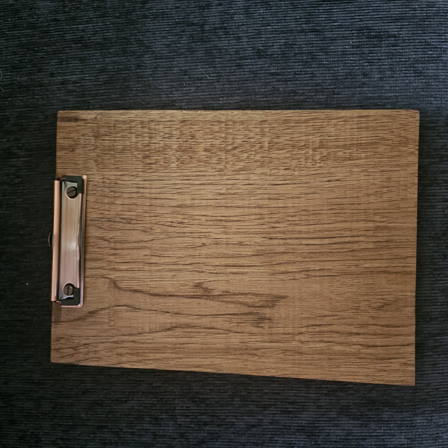 Front of the same wooden award clipboard showing its metal paper clip