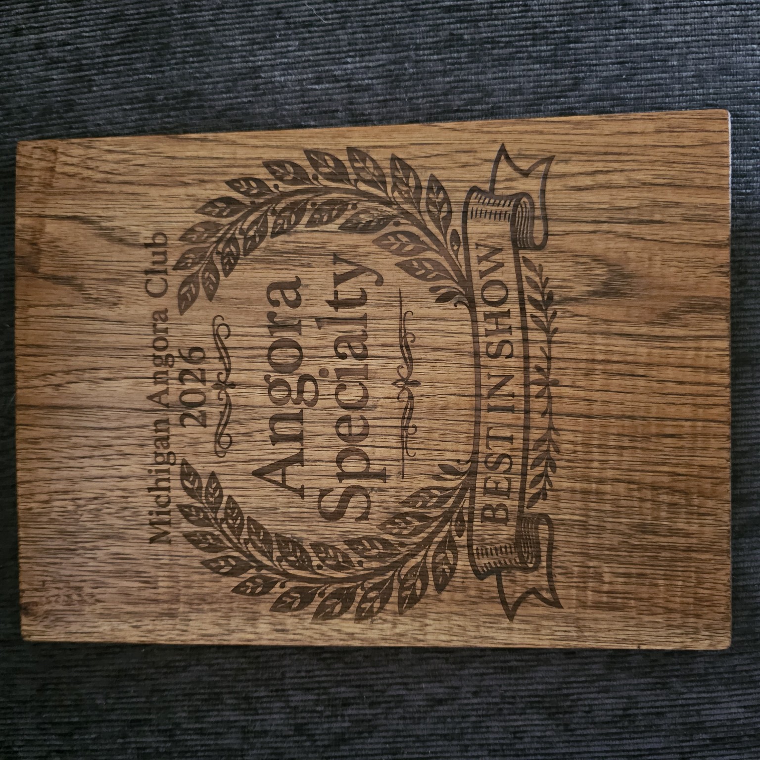 Engraved back of the Michigan Angora Club 2026 Angora Specialty Best in Show wooden clipboard