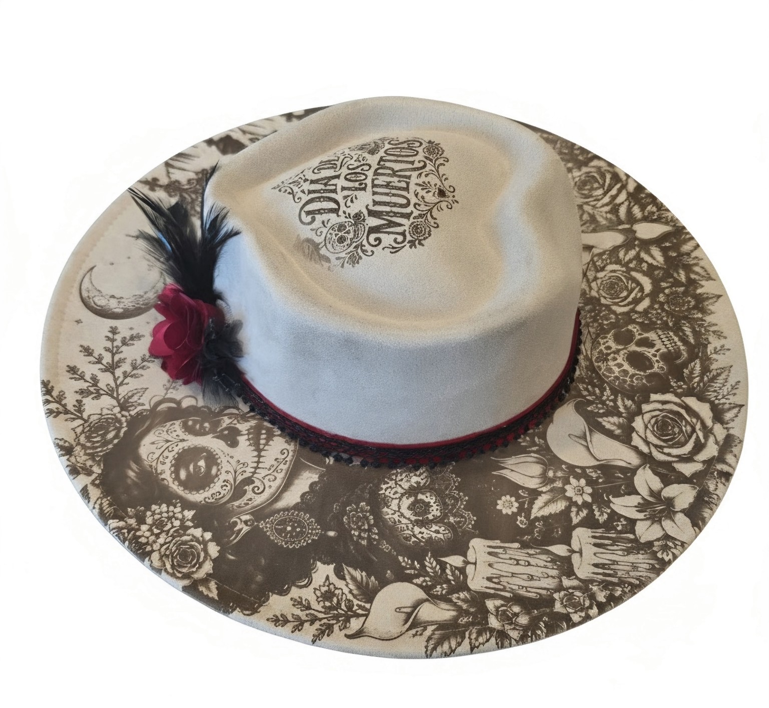 Light-colored wide-brim hat with Día de los Muertos lettering, skull and rose engraving, and red flower detail
