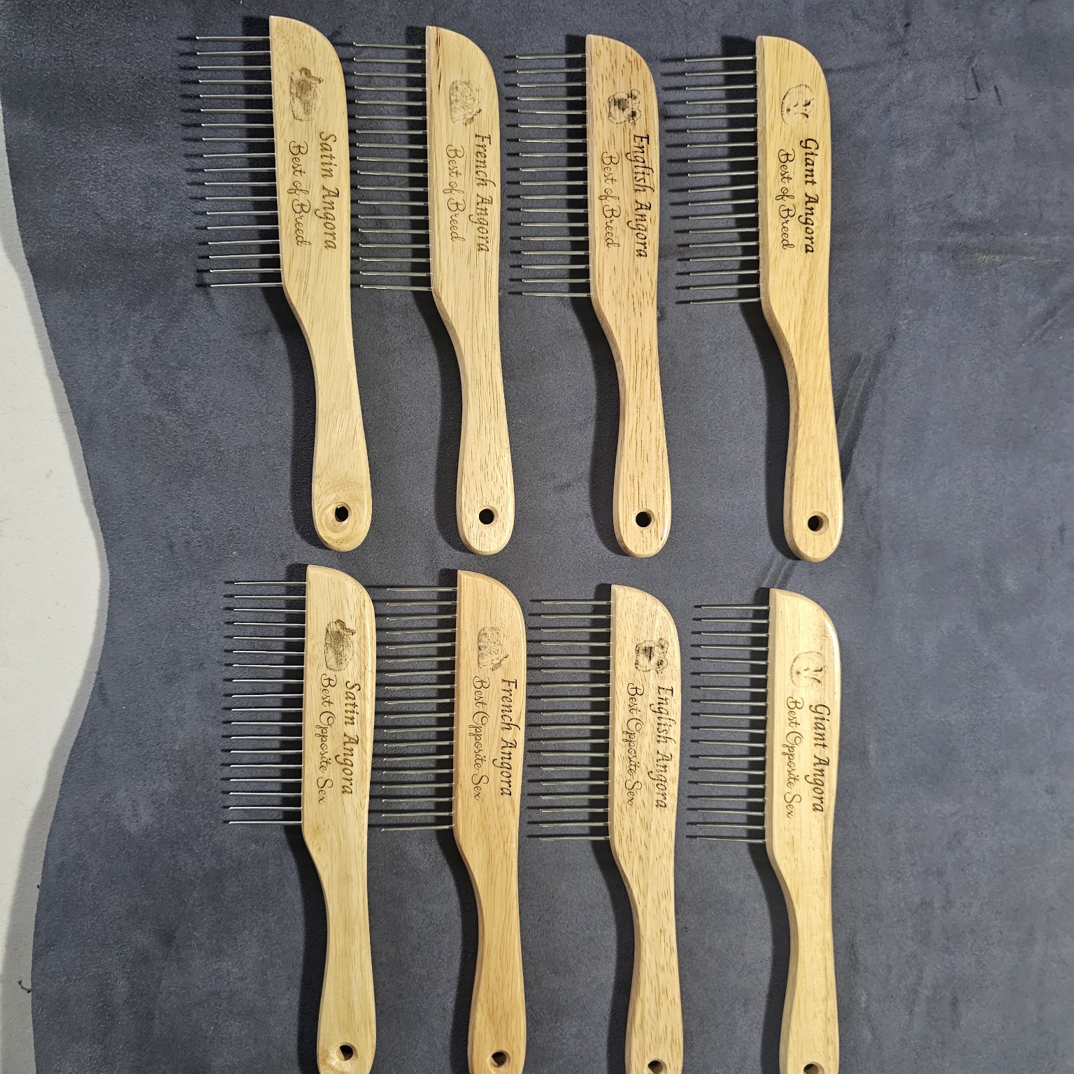 Eight wooden combs engraved for Giant, English, French, and Satin Angora Best of Breed and Best Opposite Sex awards